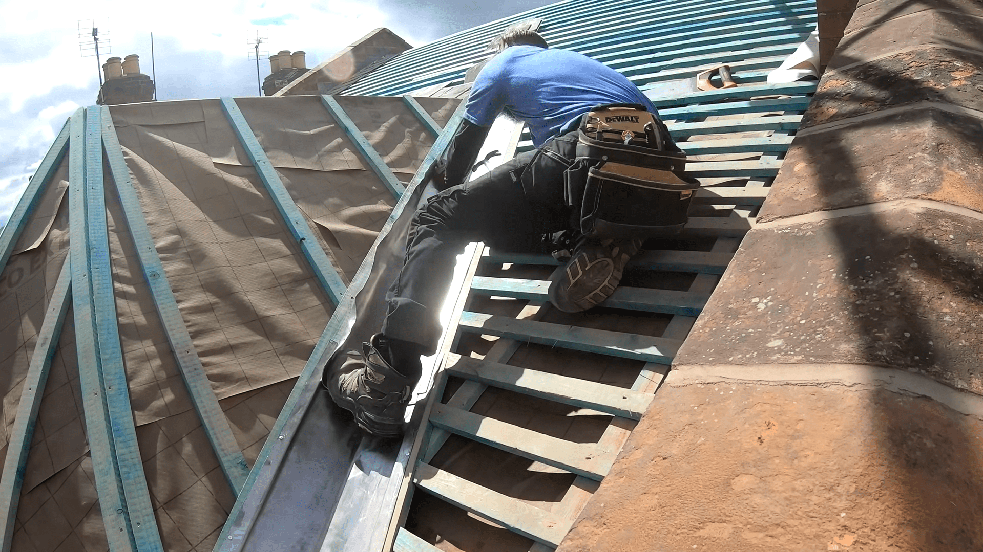 Roofers replacing tiles and battens on a residential roof in Stoke-on-Trent