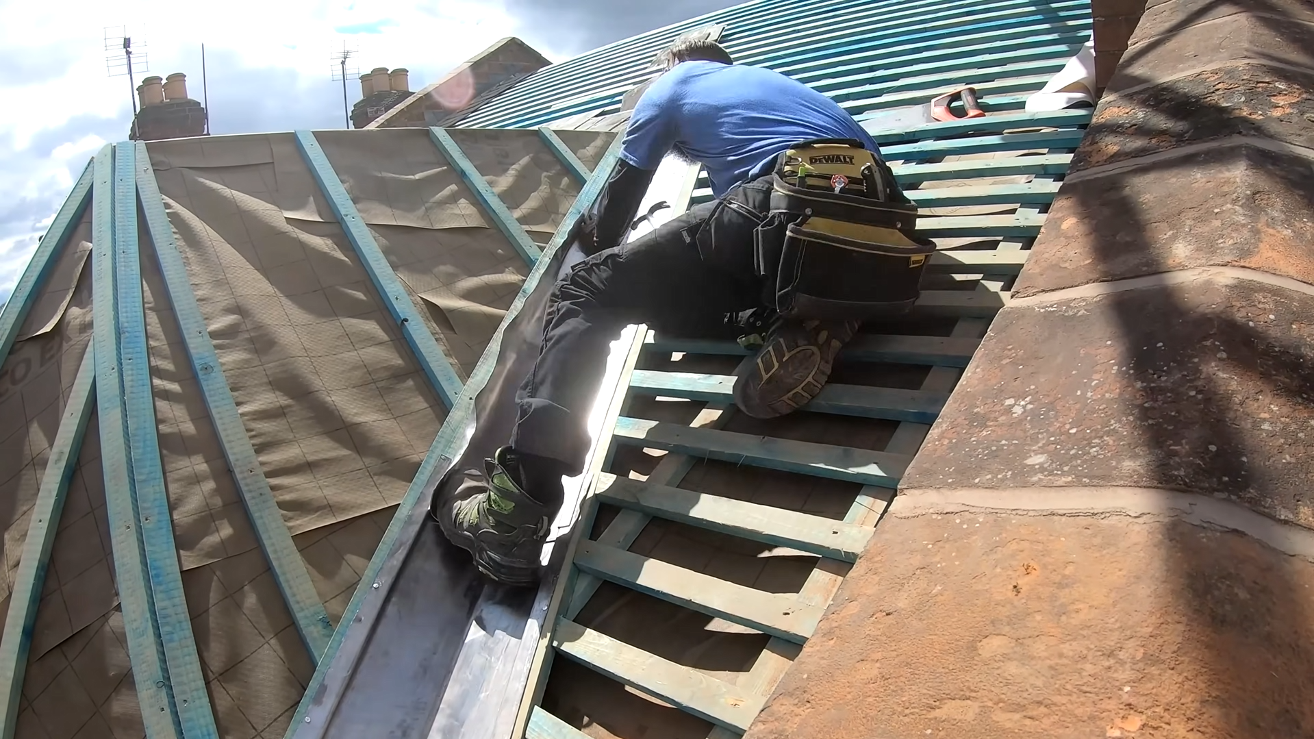 Roofers replacing tiles and battens on a residential roof in Stoke-on-Trent. Stoke-on-Trent Roofing.